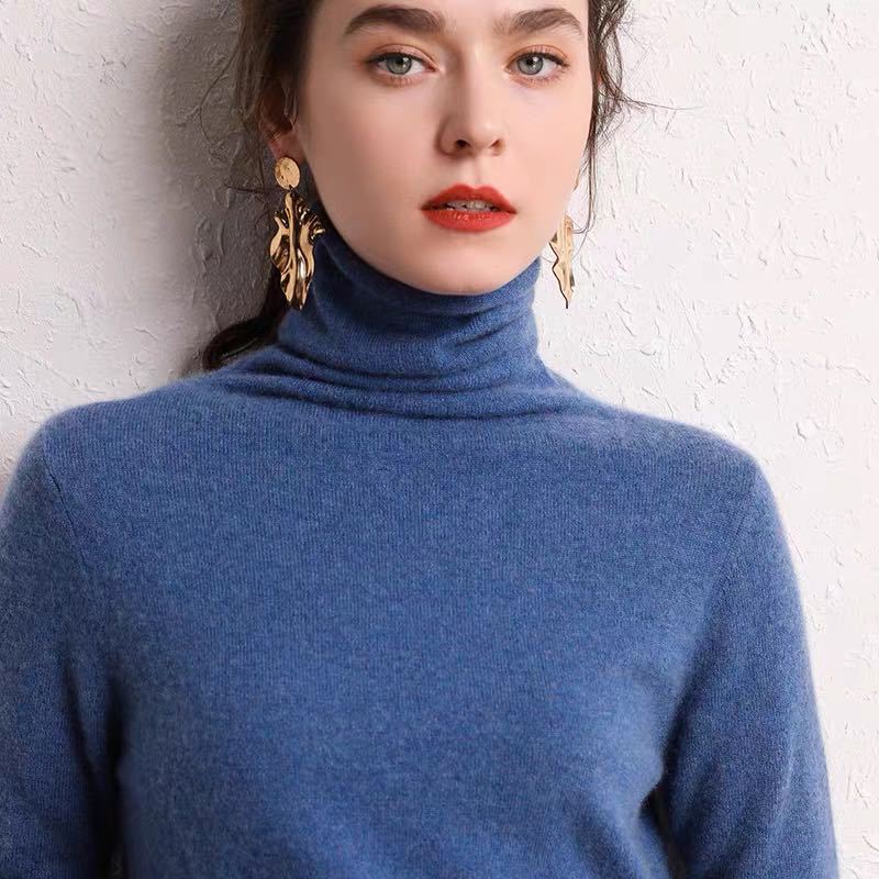 Detail of ribbed turtleneck collar on beige cashmere sweater
