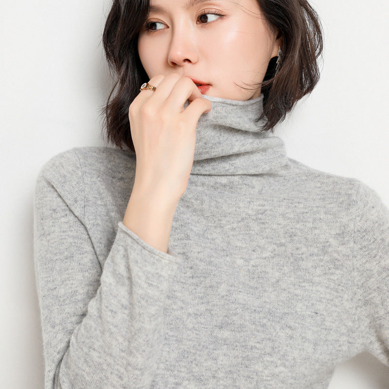 Black cashmere turtleneck sweater styled with gold jewelry