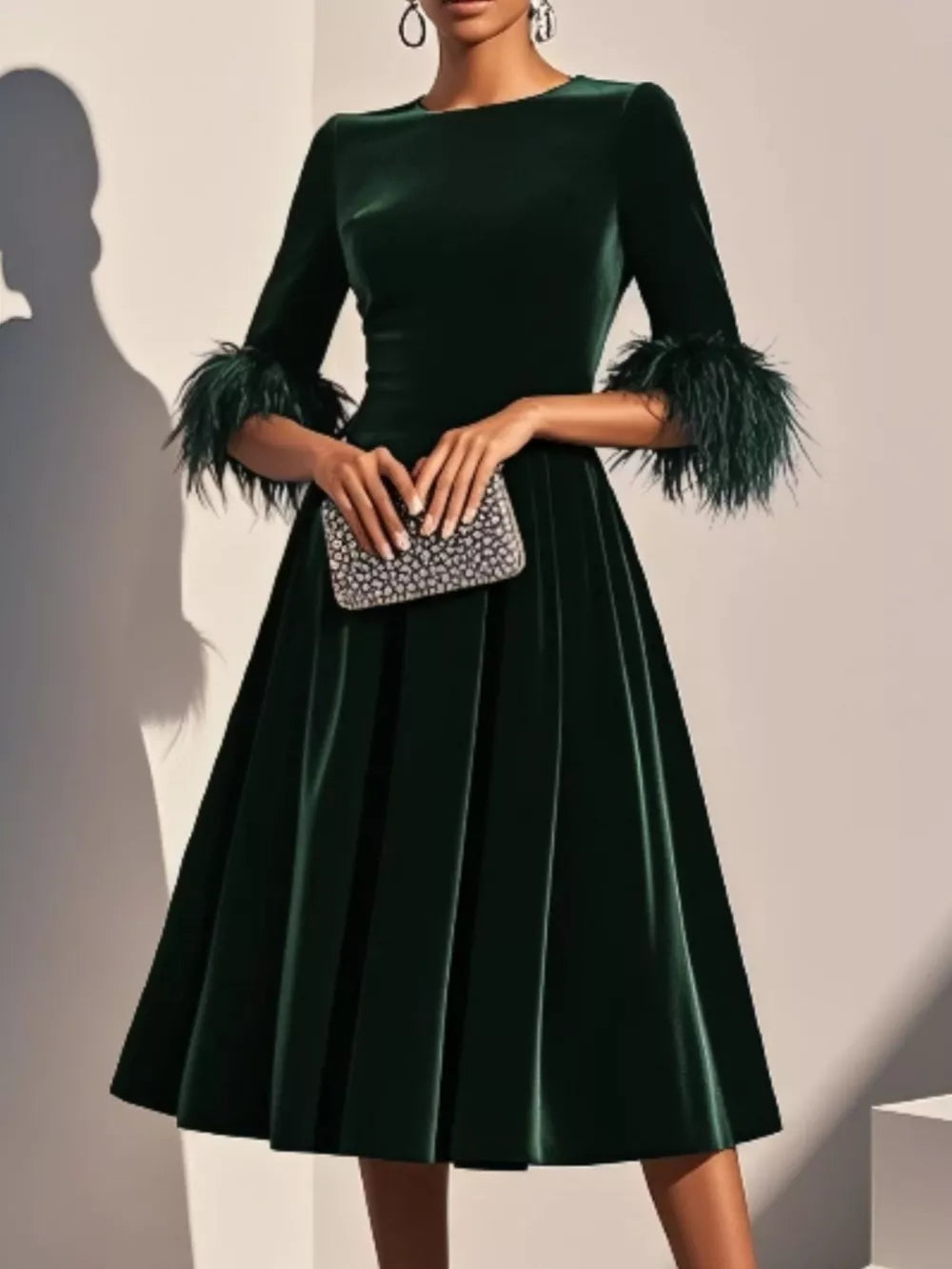 Majestic emerald green velvet midi dress with feather cuffs, front view