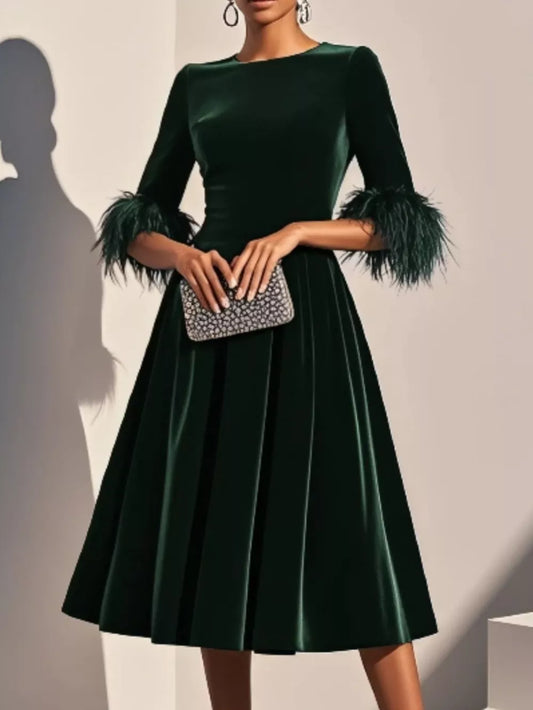 Majestic emerald green velvet midi dress with feather cuffs, front view