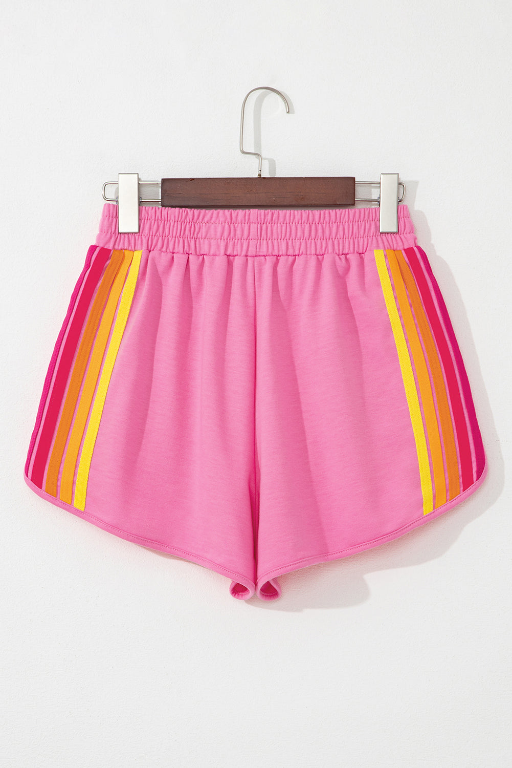Women's pink color-block athletic shorts with a high-rise waist, vibrant side stripes, and a relaxed fit.