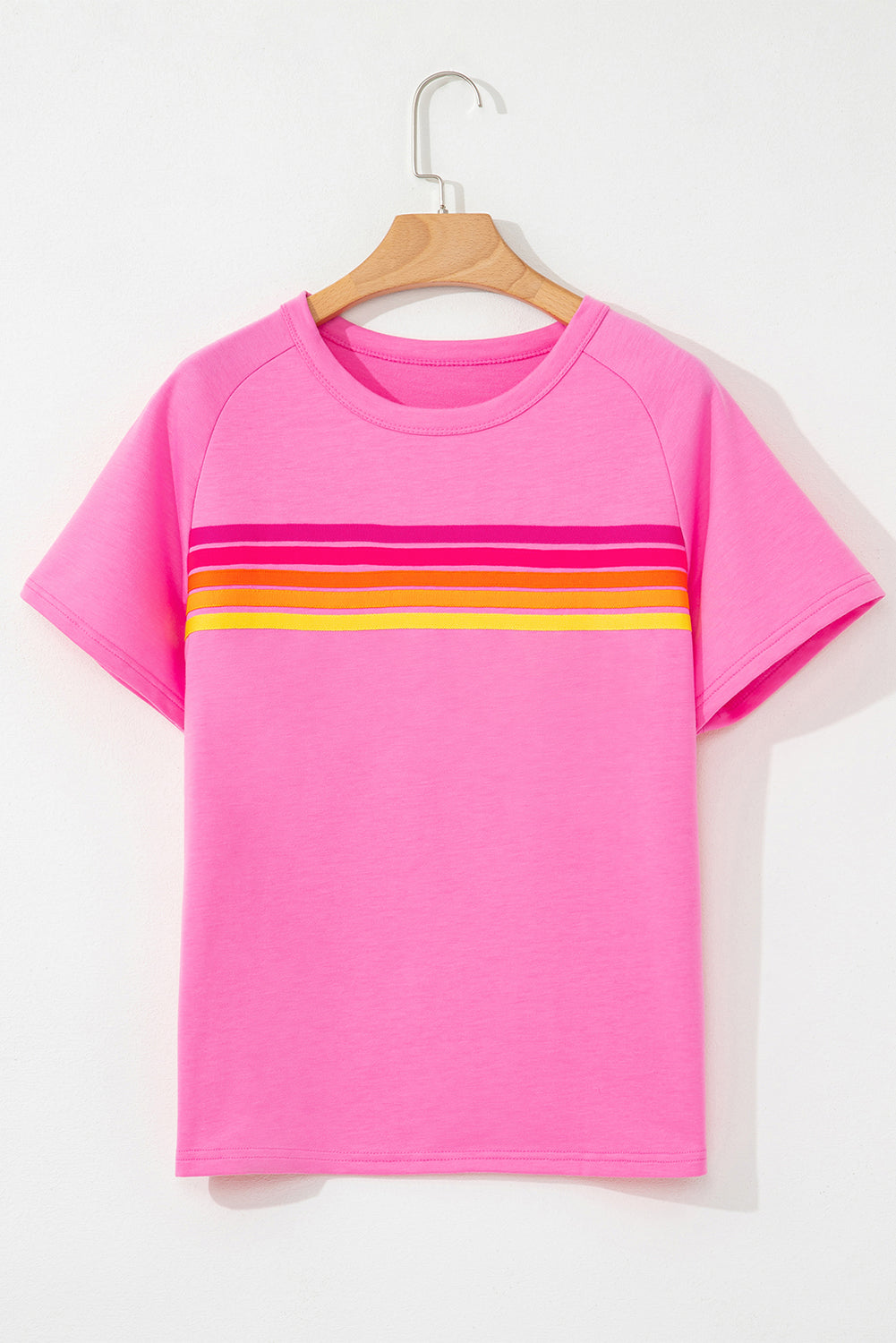 Women's pink short sleeve T-shirt with colorful horizontal stripes across the chest and a classic crew neckline