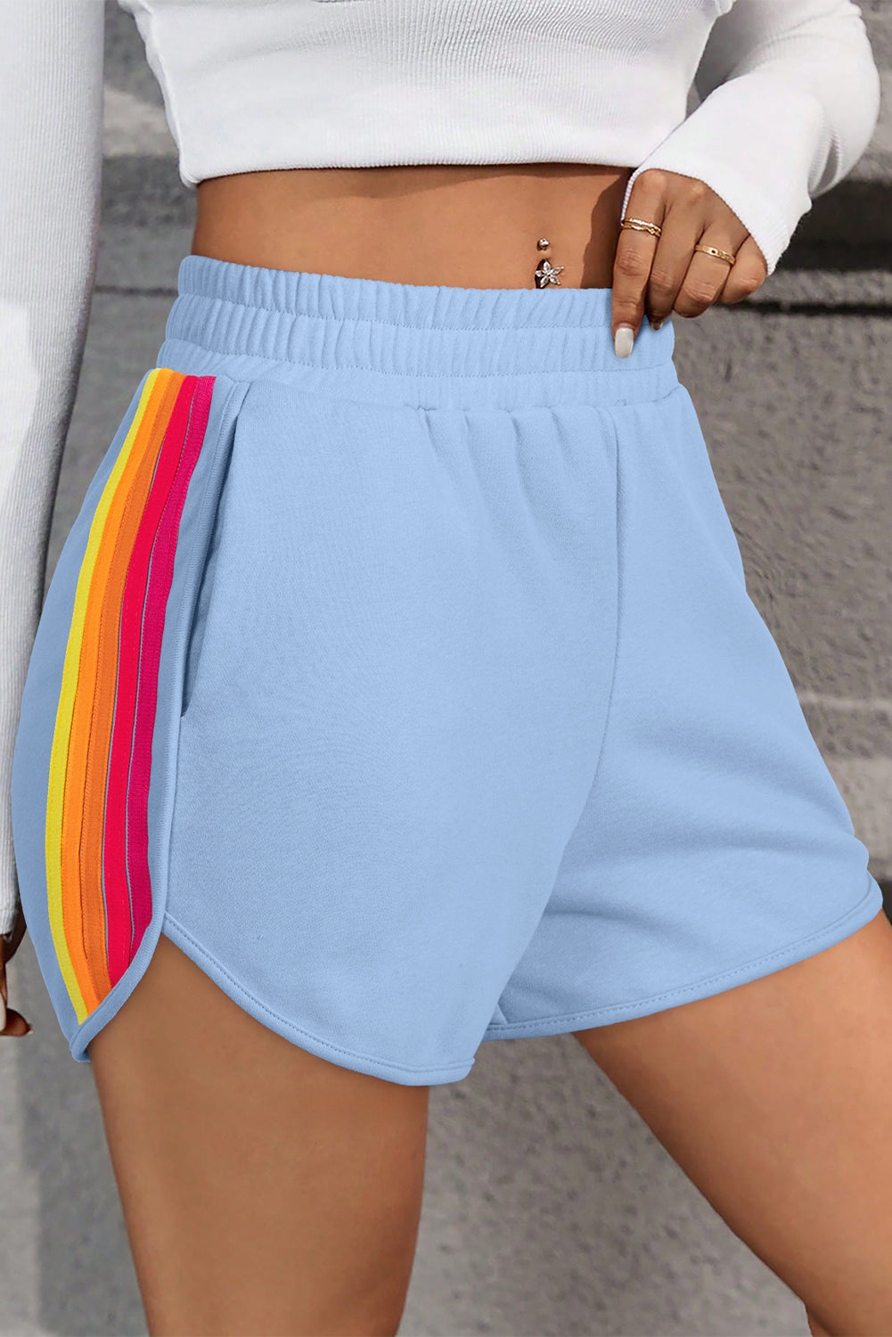 Women's blue high-waisted athletic shorts with colorful side stripe panels and a comfortable elastic waistband.