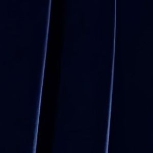 Close-up of feather cuff detail on velvet midi dress