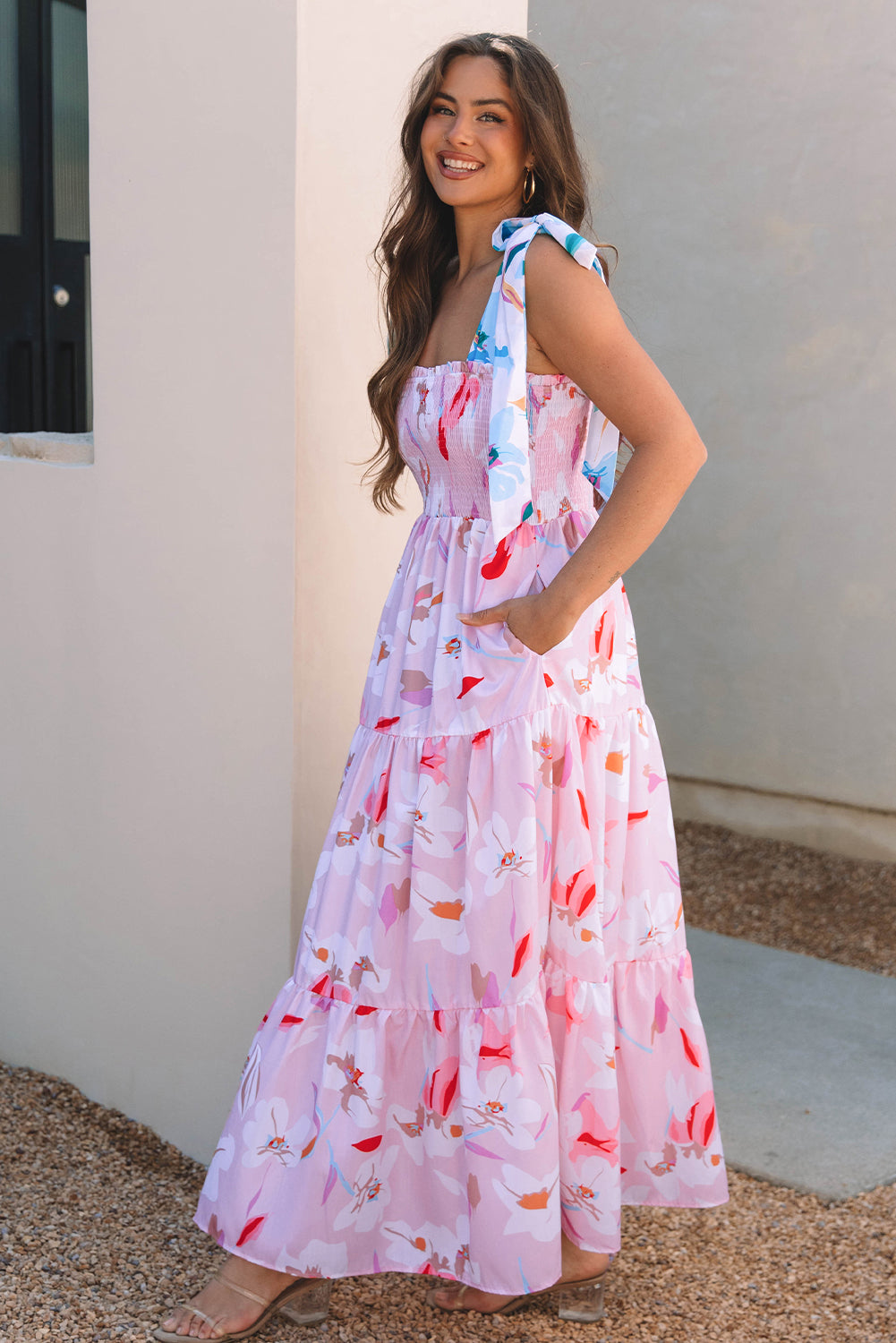 Side view of a pink floral maxi dress with a sleeveless design, flattering fit, and elegant flowing skirt.