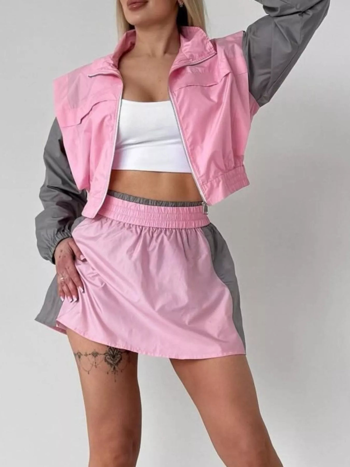 Courtside Muse color-block jacket and skort set in pink and gray